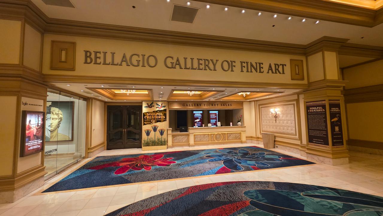 The entrance to an art gallery with framed works and soft track lighting inside Bellagio Las Vegas.